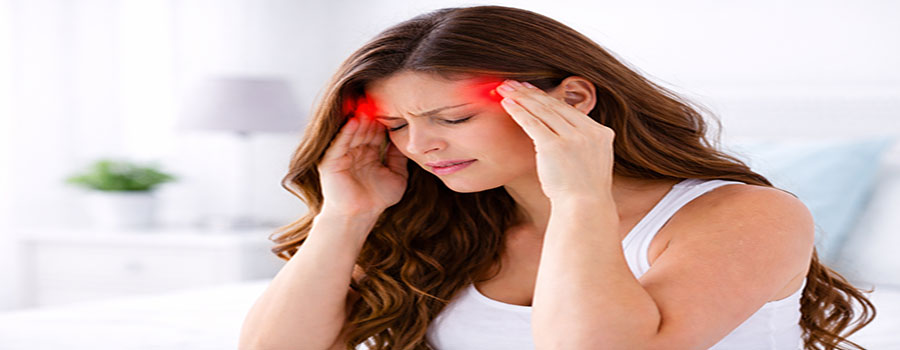 Person holding their head while looking for headache relief options in Charlotte NC