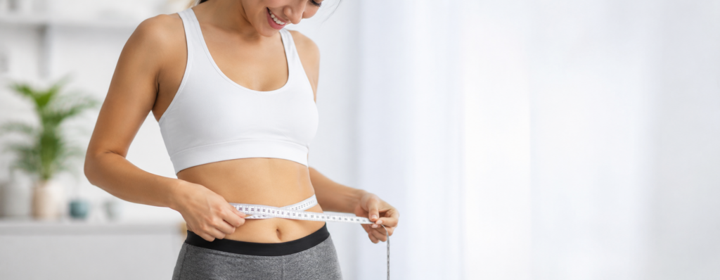 Woman using a measuring tape while working toward weight loss goals in Charlotte NC